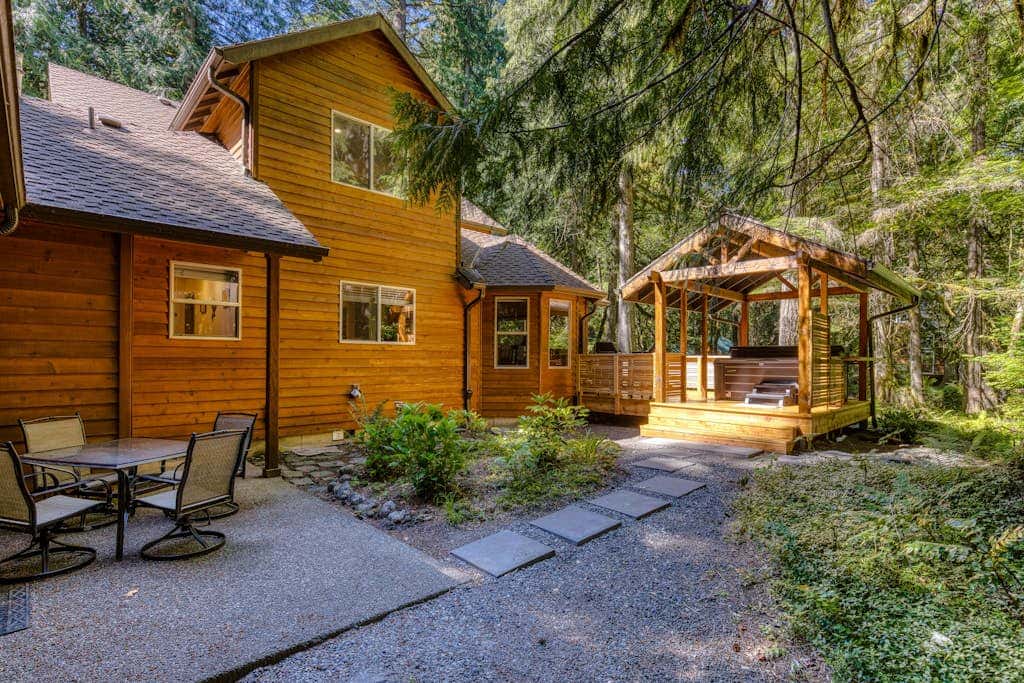Classic riverfront home with great views, game room, hot tub, & modern cabin feel