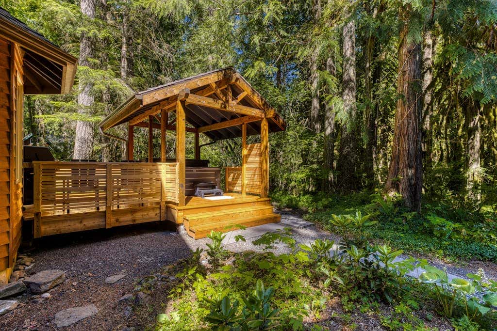 Classic riverfront home with great views, game room, hot tub, & modern cabin feel