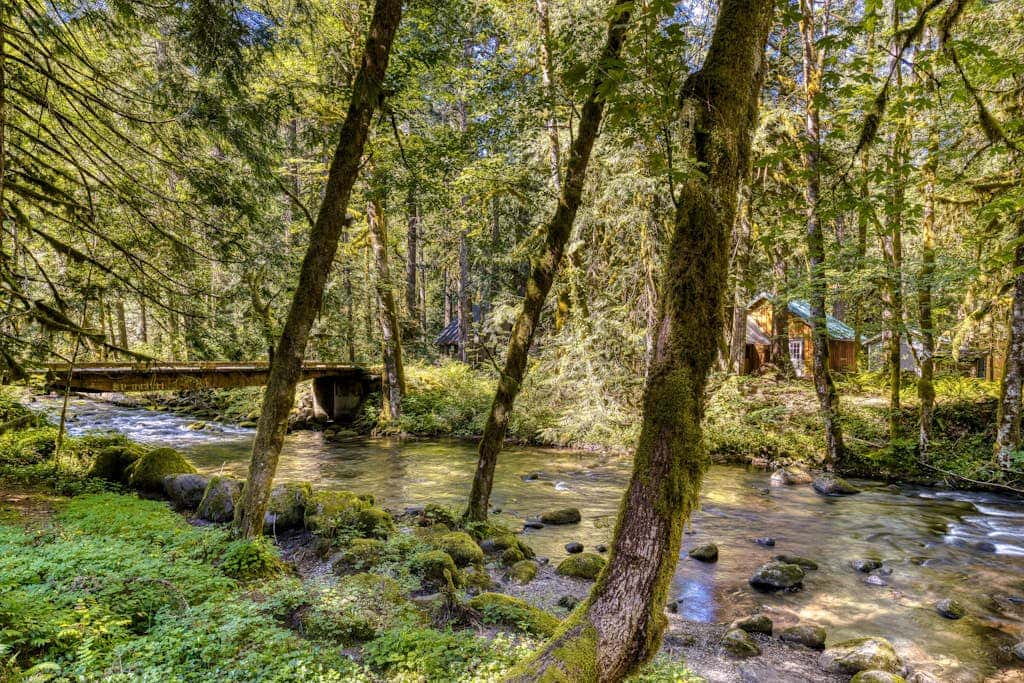 Classic riverfront home with great views, game room, hot tub, & modern cabin feel