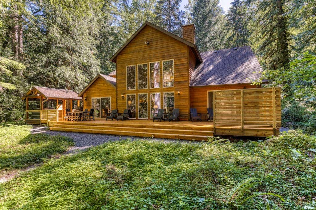 Classic riverfront home with great views, game room, hot tub, & modern cabin feel