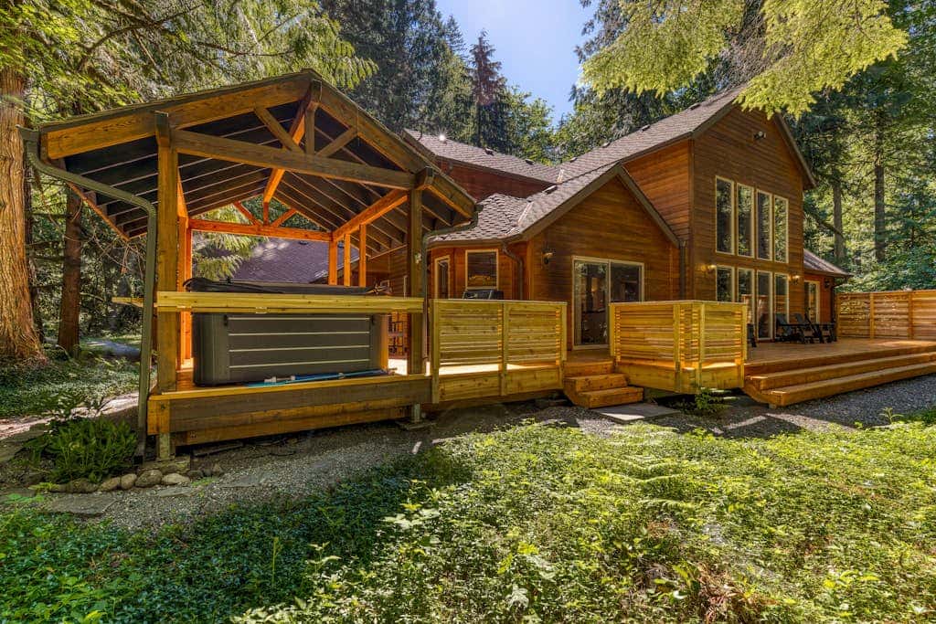 Classic riverfront home with great views, game room, hot tub, & modern cabin feel