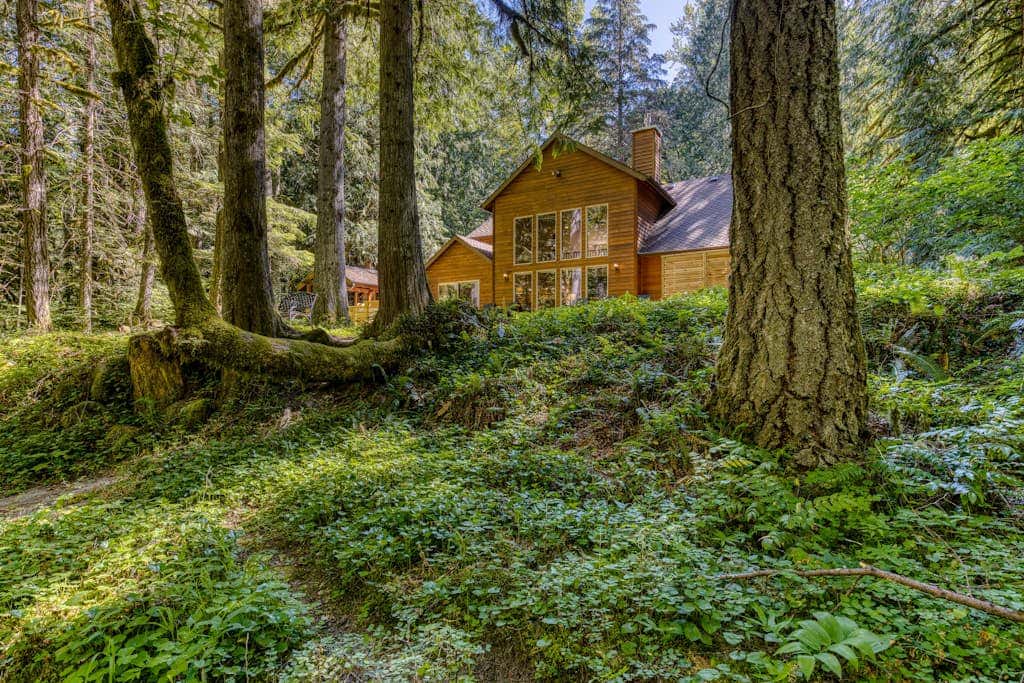 Classic riverfront home with great views, game room, hot tub, & modern cabin feel
