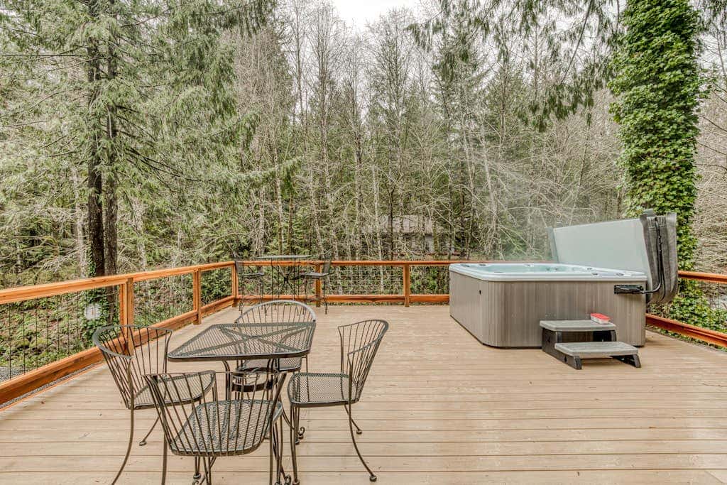 Classic forest cabin on Still Creek with private hot tub & wood fireplace