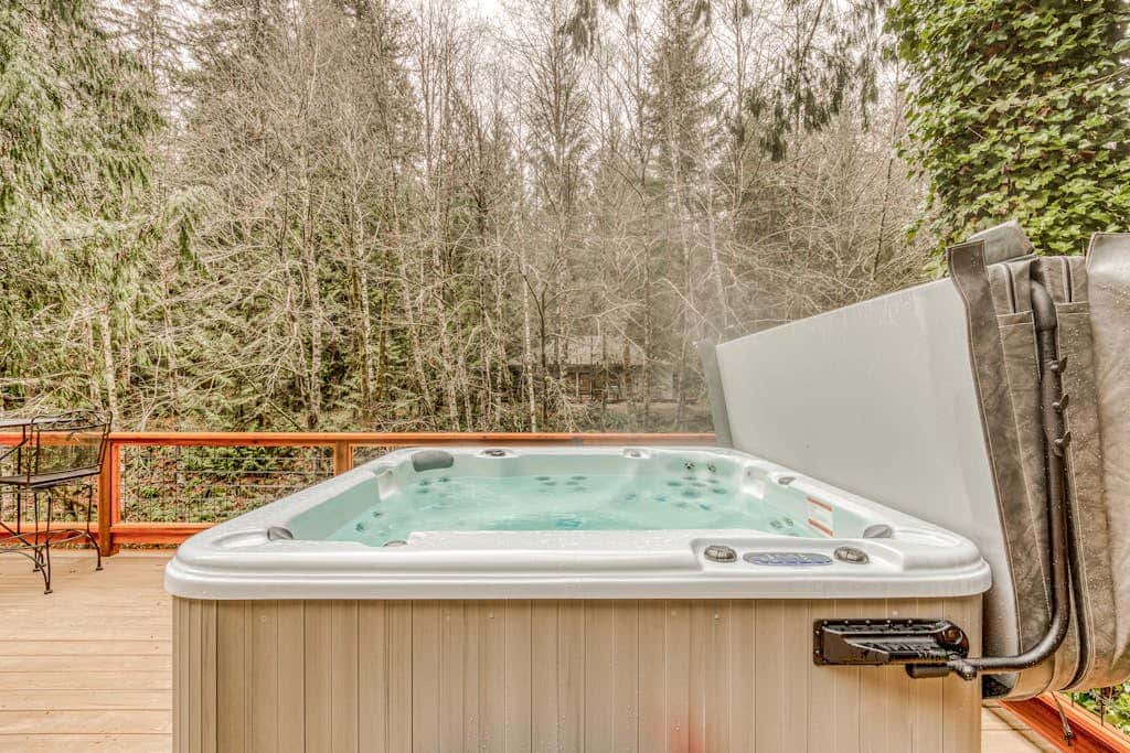 Classic forest cabin on Still Creek with private hot tub & wood fireplace