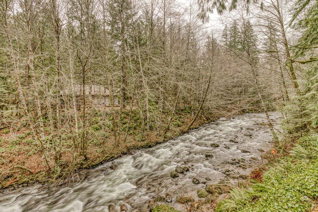 Classic forest cabin on Still Creek with private hot tub & wood fireplace