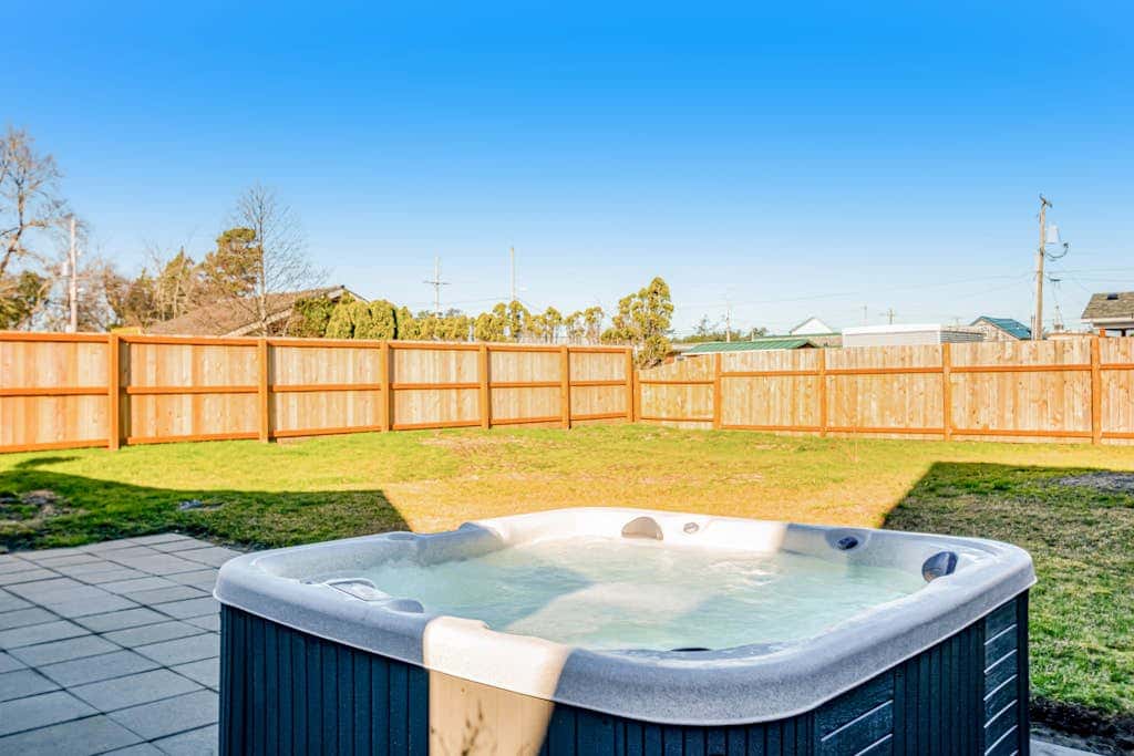 Downtown home with private hot tub & WiFi - walk to beach - dog-friendly yard