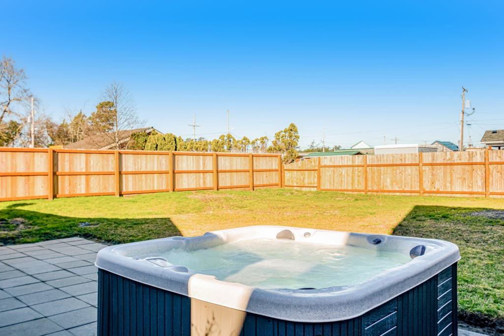 Downtown home with private hot tub & WiFi - walk to beach - dog-friendly yard