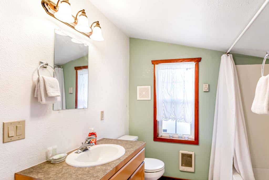 Downtown home with private hot tub & WiFi - walk to beach - dog-friendly yard