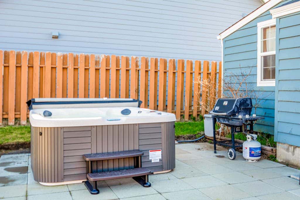 Downtown home with private hot tub & WiFi - walk to beach - dog-friendly yard