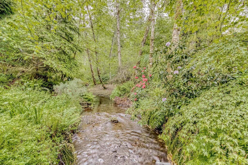 Expansive Wooded Home with a Brook, Firepit, Private Hot Tub and Shared Pool