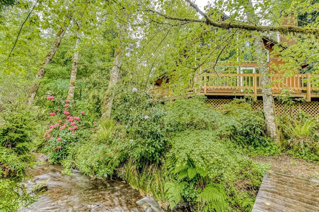 Expansive Wooded Home with a Brook, Firepit, Private Hot Tub and Shared Pool
