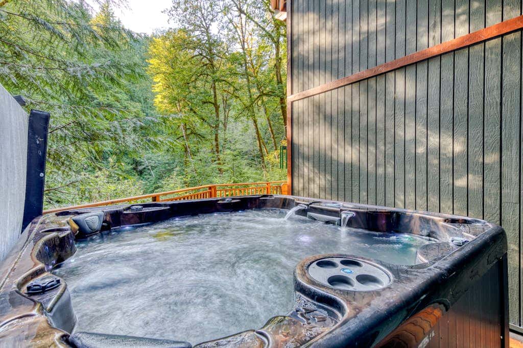 Creekside home with hot tub, deck, & great woodland views