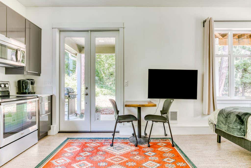 Dog-friendly studio with river view, patio, grill, & shared W&D