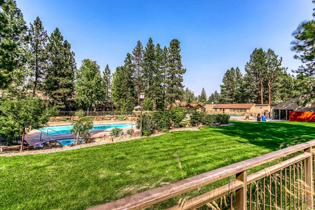 Third-floor retreat with treetop views, AC, pools, hot tubs, & sports courts