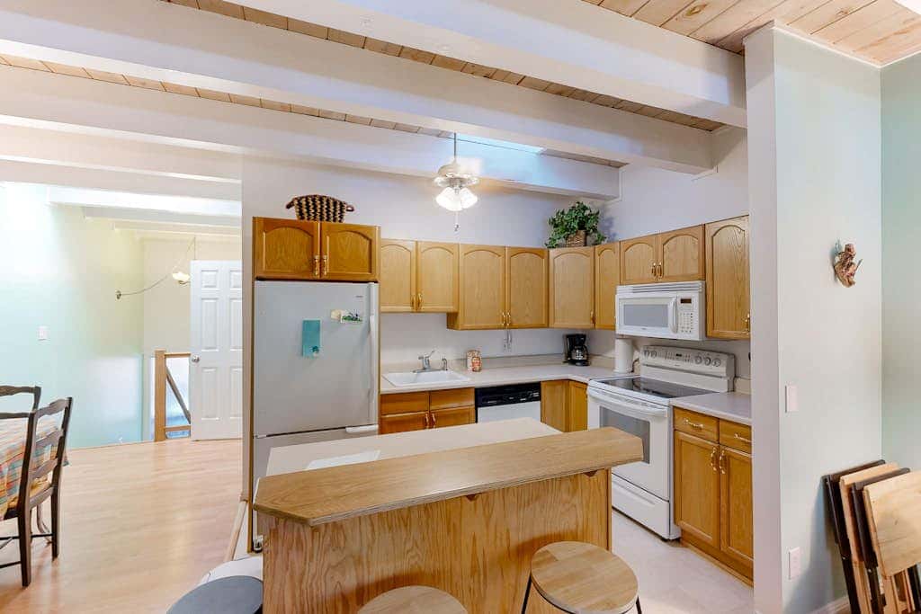 Forest-view condo with wood fireplace & walkable locale - dog-friendly