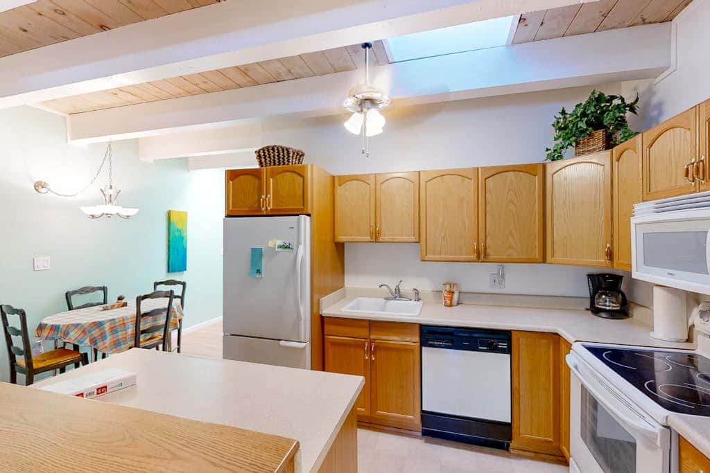 Forest-view condo with wood fireplace & walkable locale - dog-friendly
