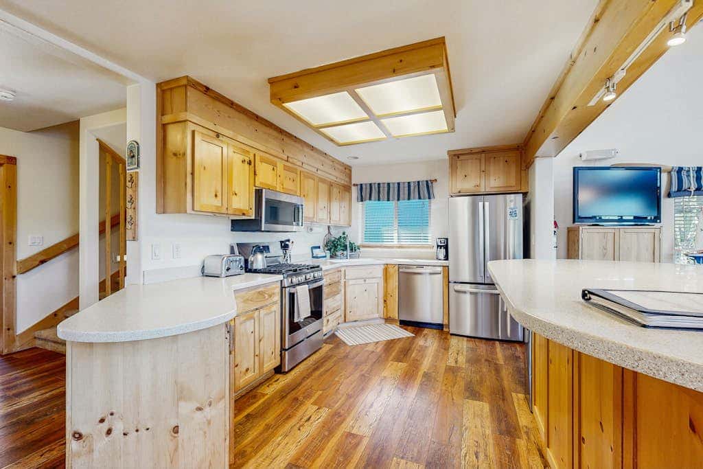 Family-friendly, lakefront getaway with a gas fireplace, furnished deck, & views
