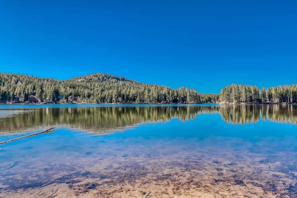 Family-friendly, lakefront getaway with a gas fireplace, furnished deck, & views