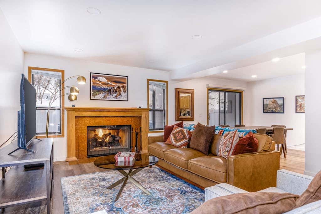 Central townhouse with private hot tub, wood fireplace, & ski shuttle access