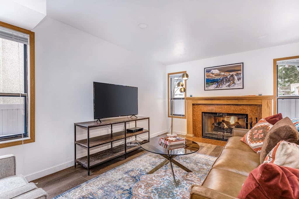 Central townhouse with private hot tub, wood fireplace, & ski shuttle access