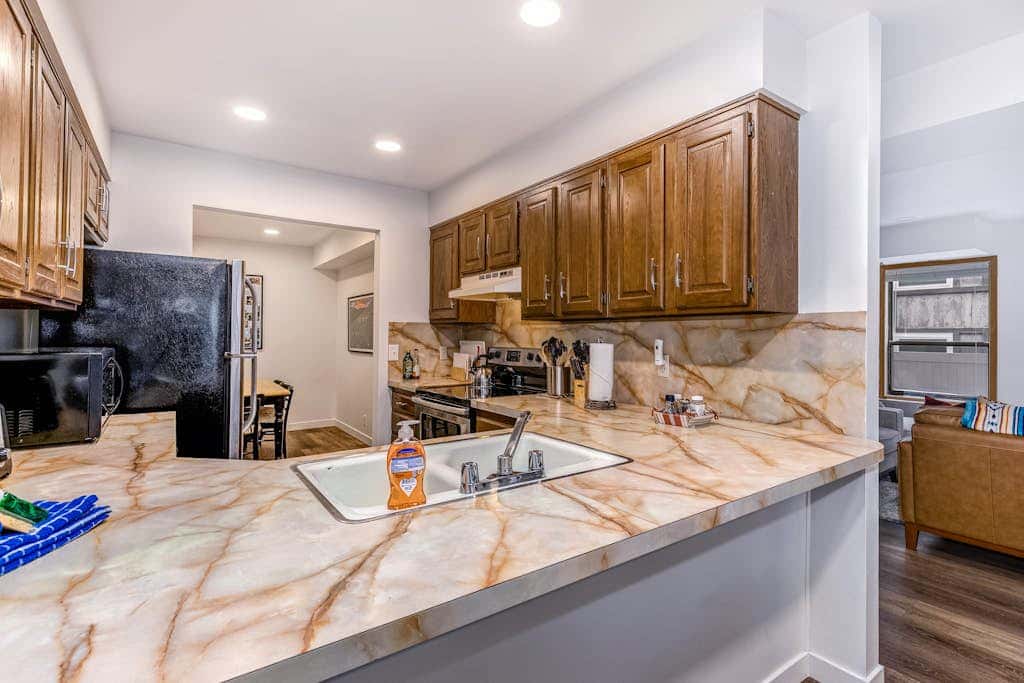 Central townhouse with private hot tub, wood fireplace, & ski shuttle access