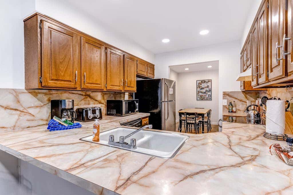 Central townhouse with private hot tub, wood fireplace, & ski shuttle access