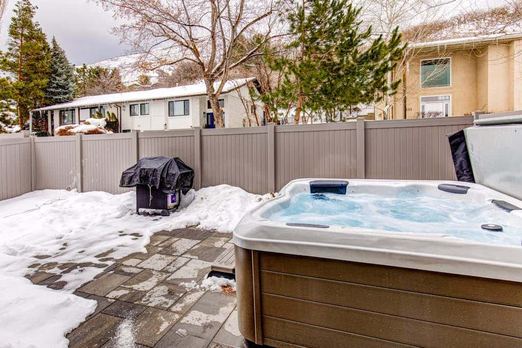 Central townhouse with private hot tub, wood fireplace, & ski shuttle access