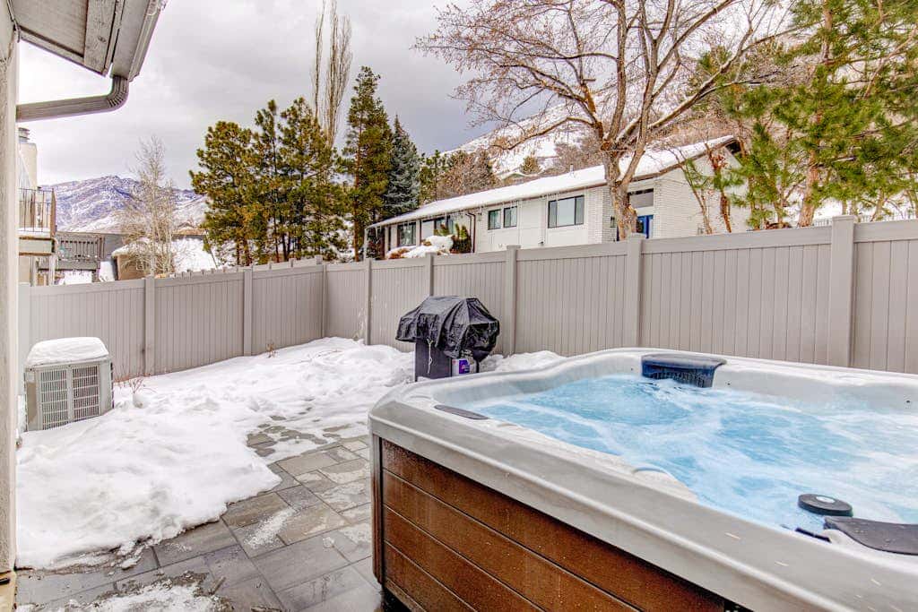 Central townhouse with private hot tub, wood fireplace, & ski shuttle access