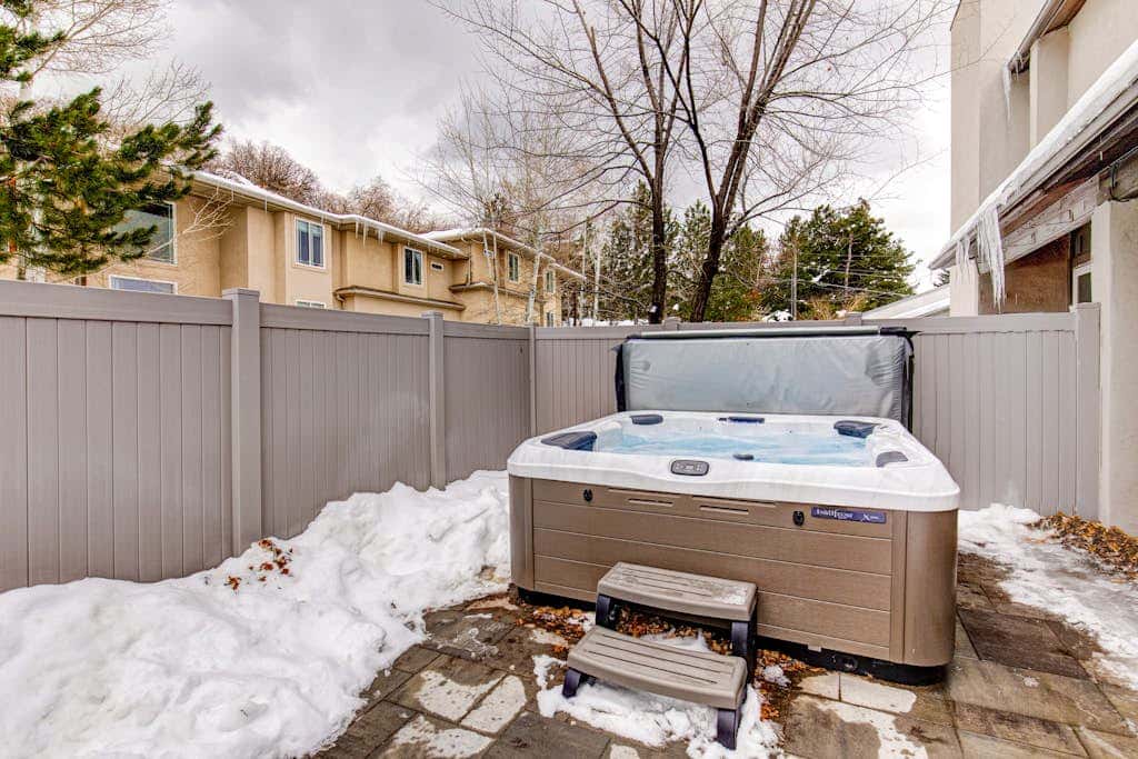 Central townhouse with private hot tub, wood fireplace, & ski shuttle access