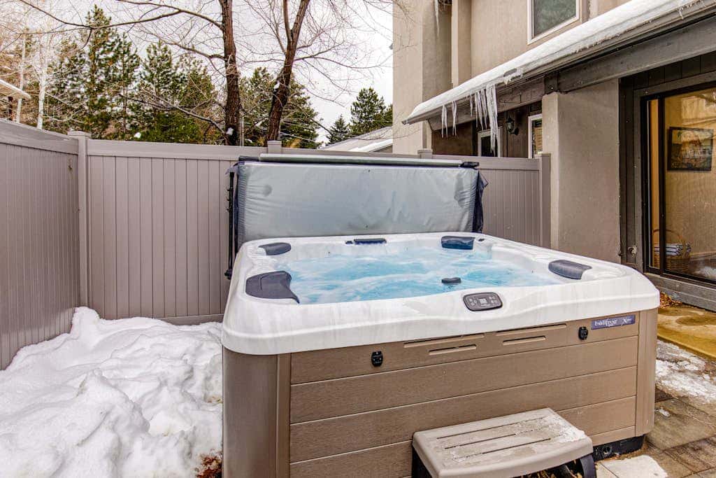 Central townhouse with private hot tub, wood fireplace, & ski shuttle access