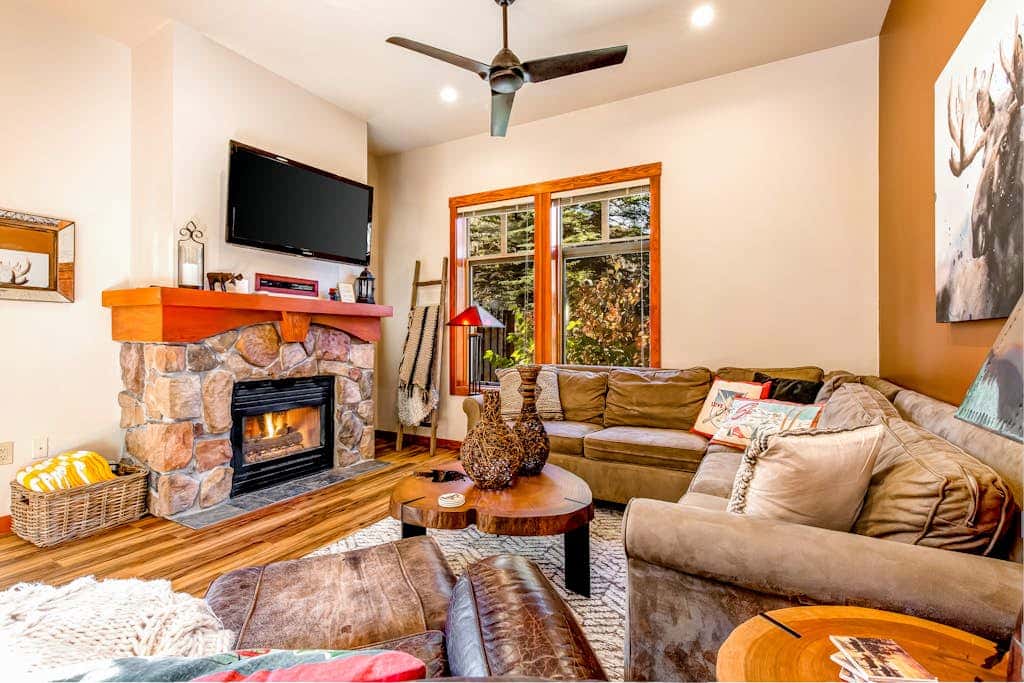 ski-in - ski-out condo with a deck, ski views & a shared pool and hot tub