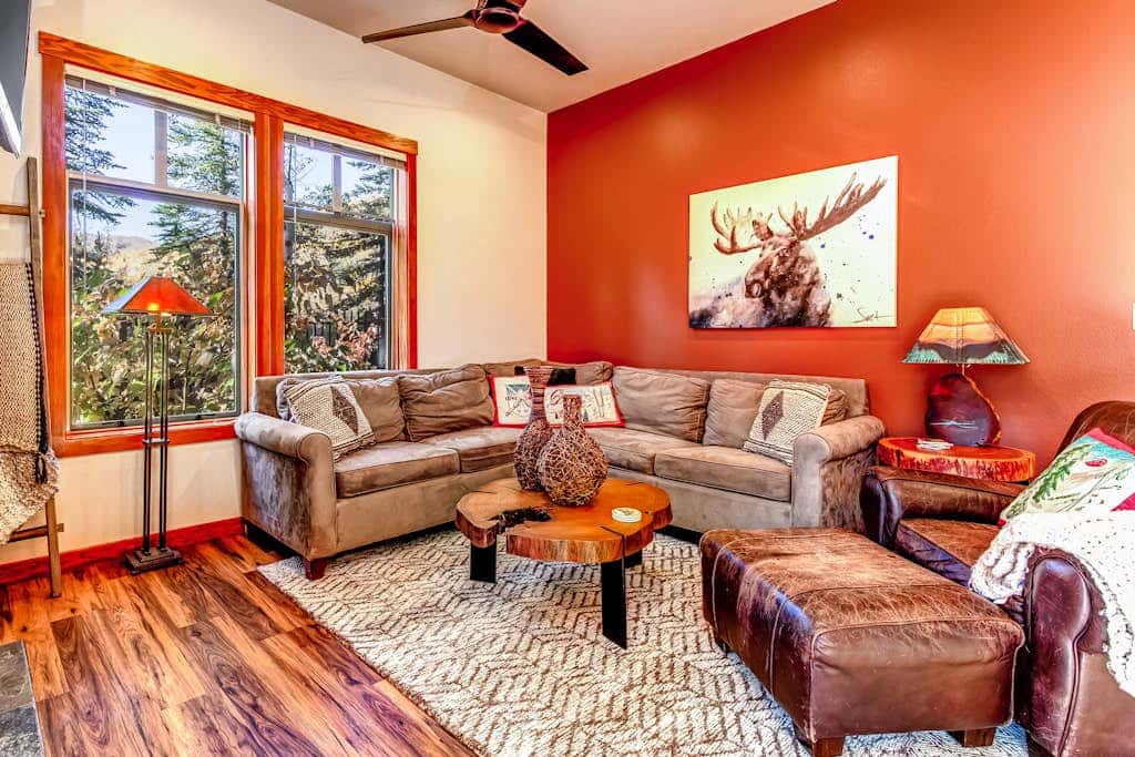 ski-in - ski-out condo with a deck, ski views & a shared pool and hot tub