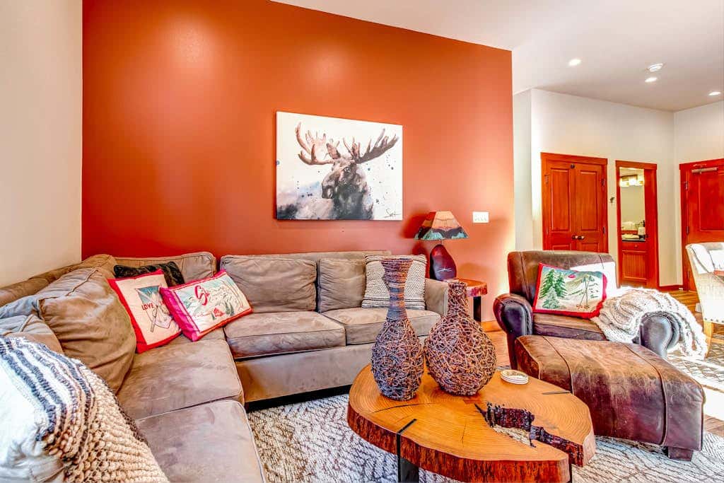 ski-in - ski-out condo with a deck, ski views & a shared pool and hot tub