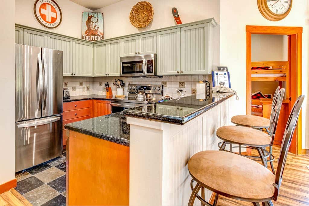 ski-in - ski-out condo with a deck, ski views & a shared pool and hot tub