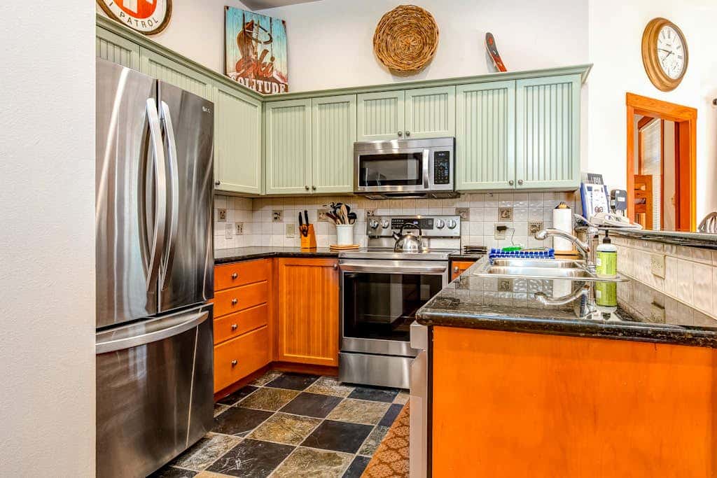 ski-in - ski-out condo with a deck, ski views & a shared pool and hot tub