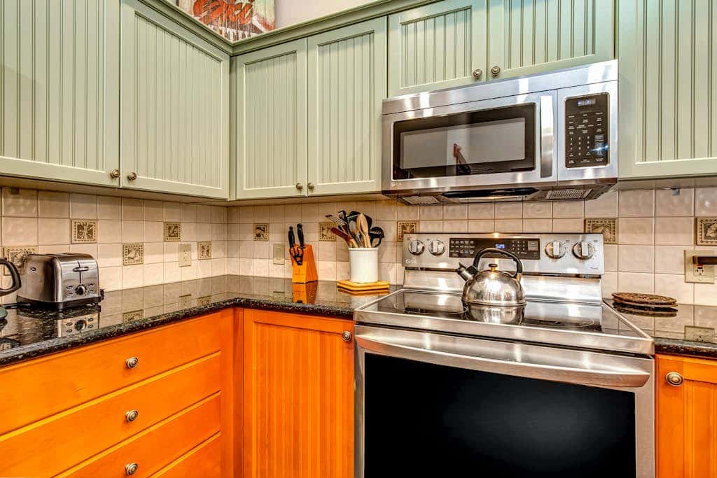 ski-in - ski-out condo with a deck, ski views & a shared pool and hot tub