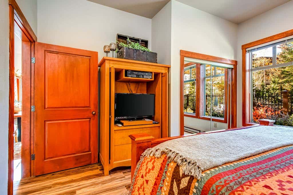 ski-in - ski-out condo with a deck, ski views & a shared pool and hot tub