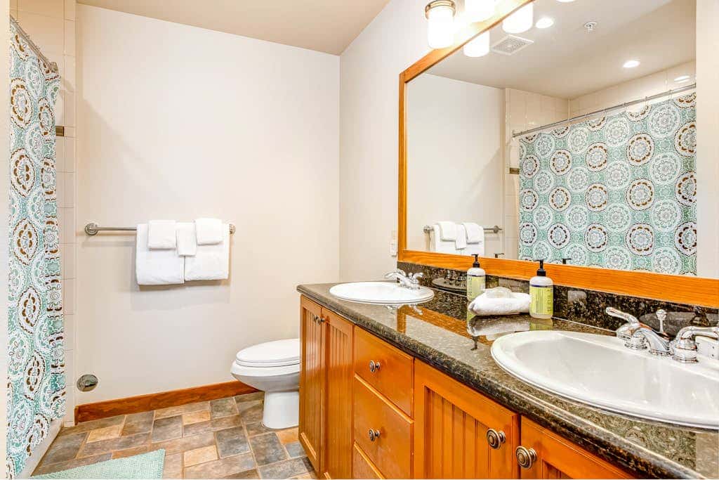ski-in - ski-out condo with a deck, ski views & a shared pool and hot tub