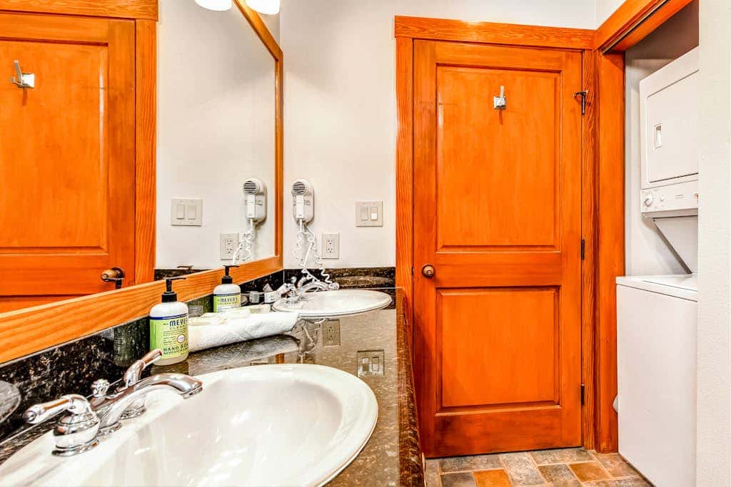 ski-in - ski-out condo with a deck, ski views & a shared pool and hot tub
