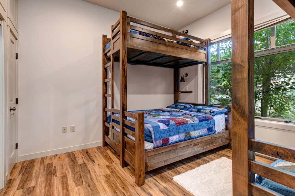 ski-in - ski-out condo with a deck, ski views & a shared pool and hot tub