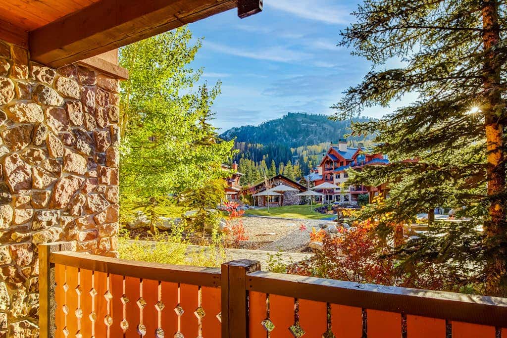 ski-in - ski-out condo with a deck, ski views & a shared pool and hot tub