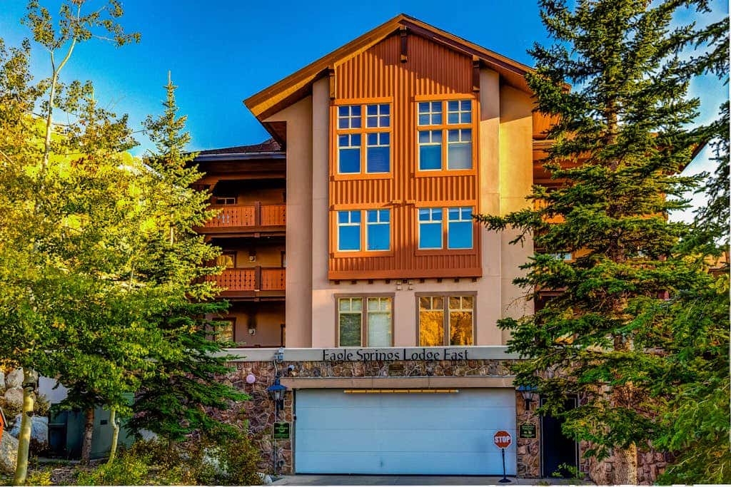 ski-in - ski-out condo with a deck, ski views & a shared pool and hot tub