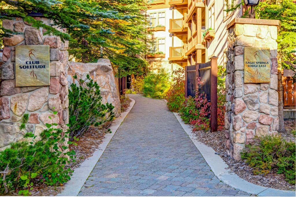 ski-in - ski-out condo with a deck, ski views & a shared pool and hot tub