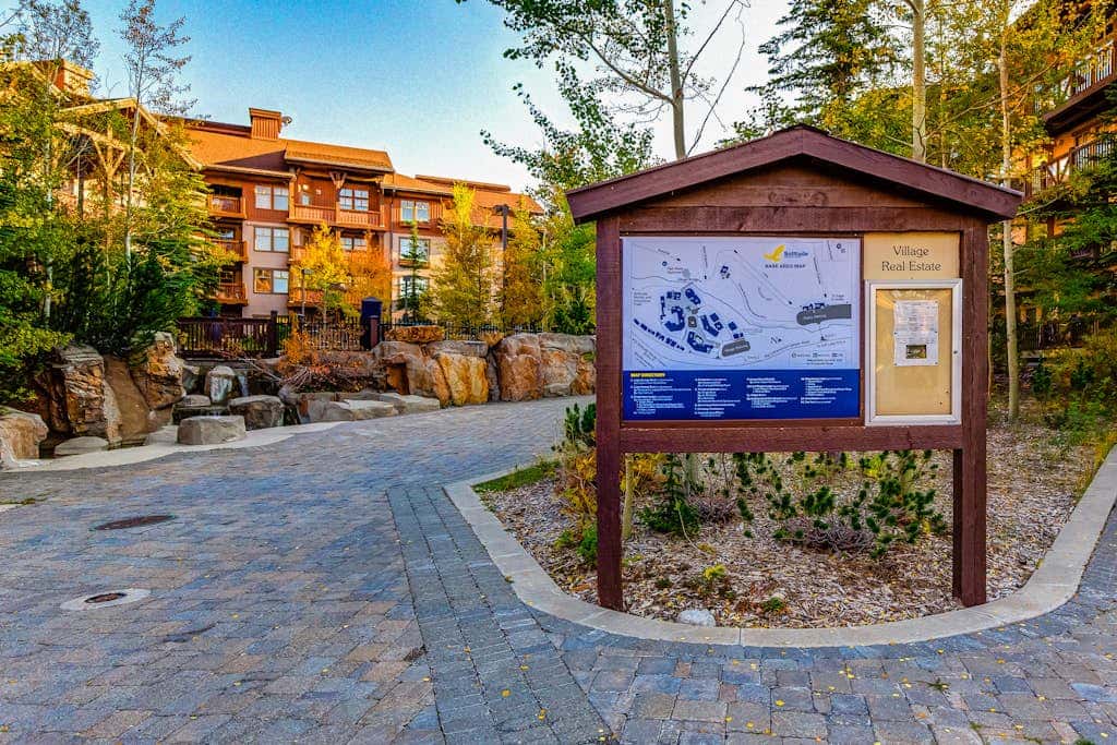ski-in - ski-out condo with a deck, ski views & a shared pool and hot tub