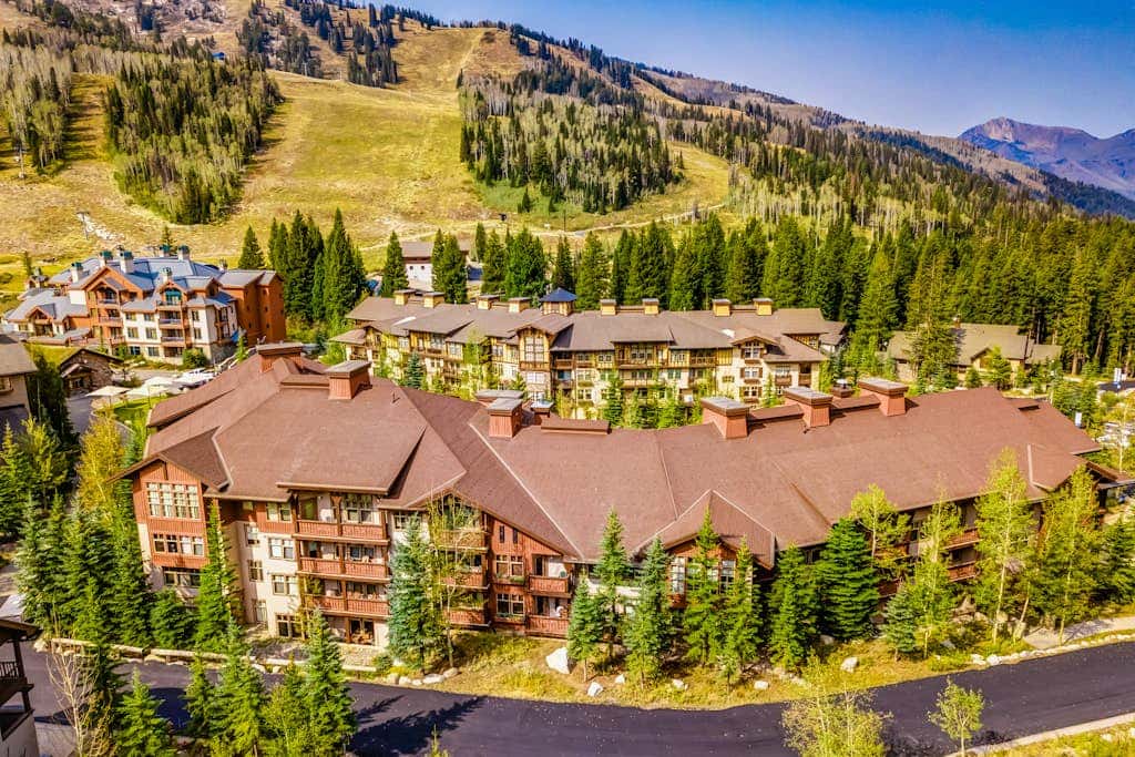 ski-in - ski-out condo with a deck, ski views & a shared pool and hot tub