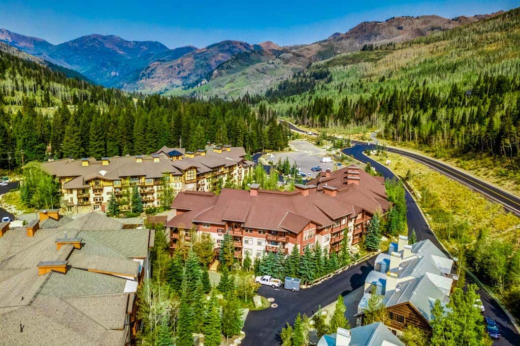 ski-in - ski-out condo with a deck, ski views & a shared pool and hot tub