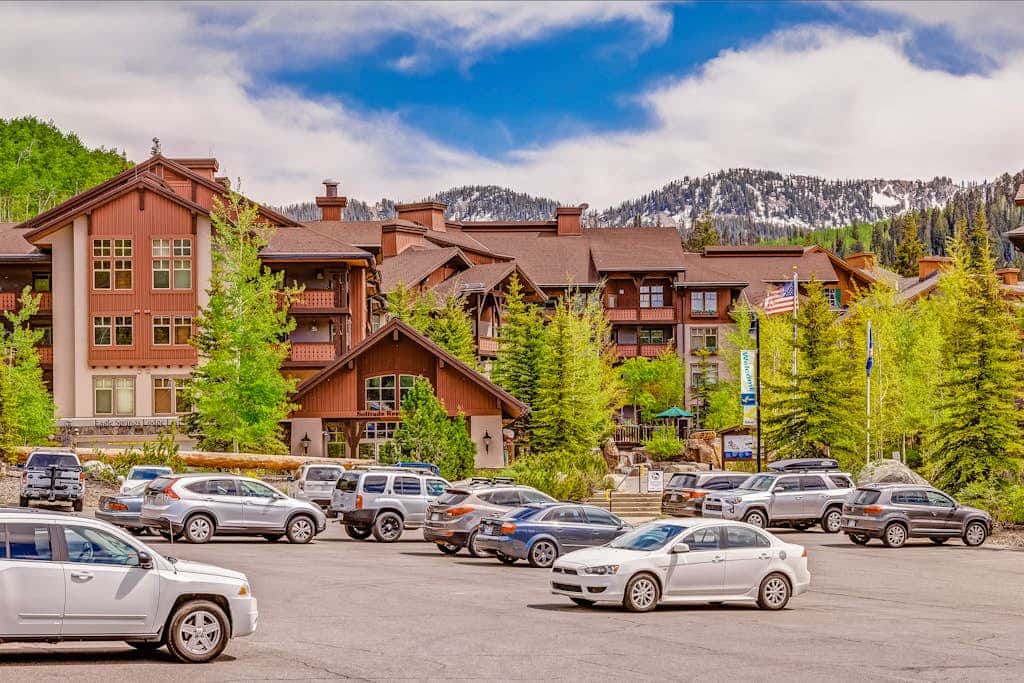 ski-in - ski-out condo with a deck, ski views & a shared pool and hot tub