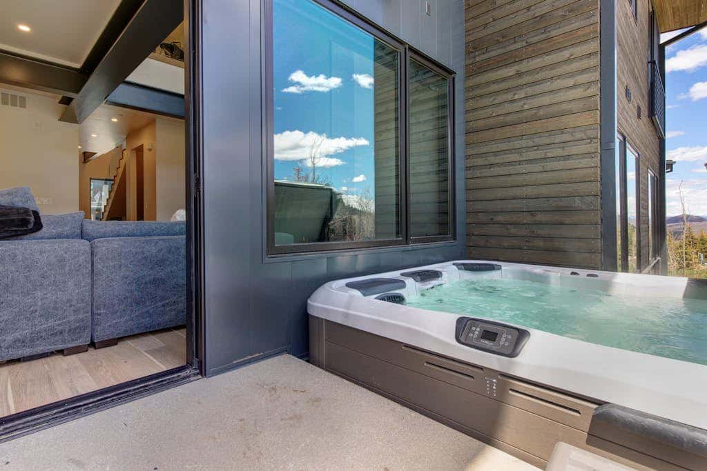 Updated home with a private hot tub, fireplace, & mountain views - dog friendly