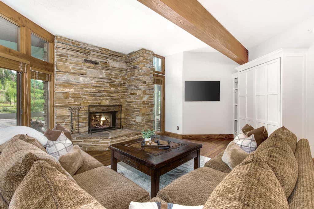 Luxury Deer Valley condo featuring a private hot tub and cozy stone fireplace.