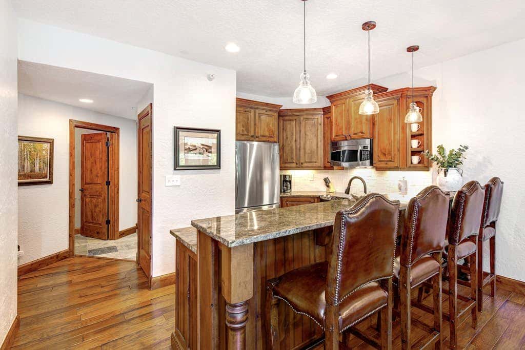 Luxury Deer Valley condo featuring a private hot tub and cozy stone fireplace.